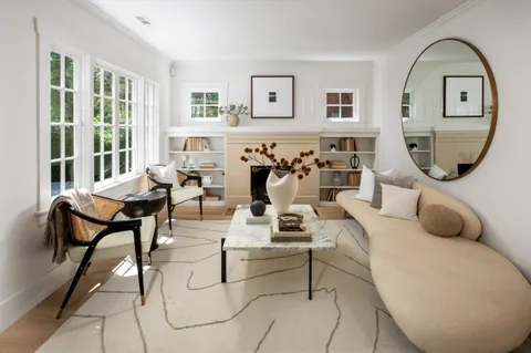 a living room with furniture flowerpot and window