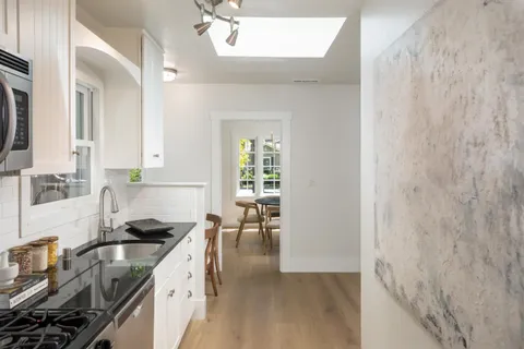 a kitchen with a sink stove and cabinets