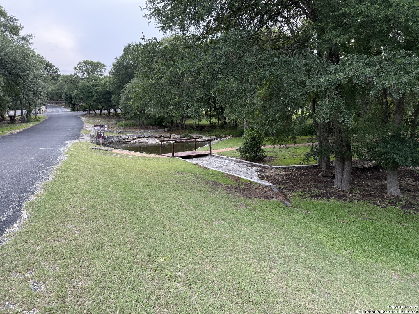 433 Pr 1706 Helotes, TX 78023 - Photo 5 of 9 a view of a backyard with large trees