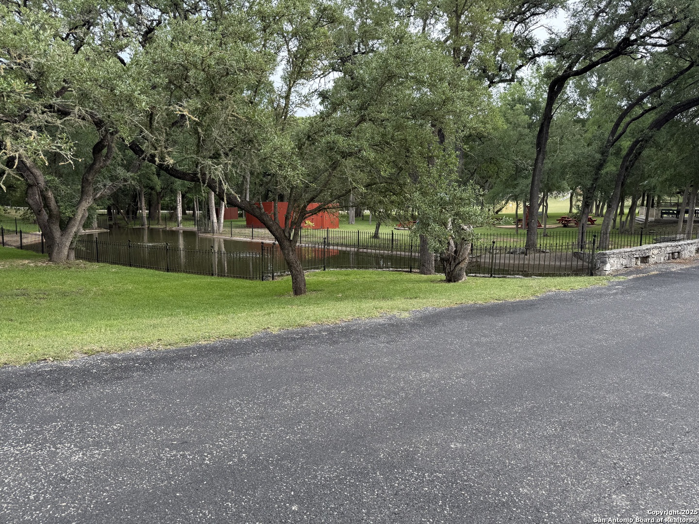 433 Pr 1706 Helotes, TX 78023 - Photo 6 of 9 a view of a house with a big yard and large trees