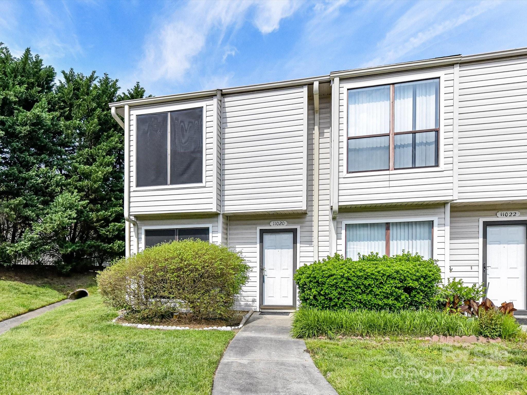 11020 Carmel Crossing Road Charlotte, NC 28226 - Photo 1 of 30 a front view of a house with garden
