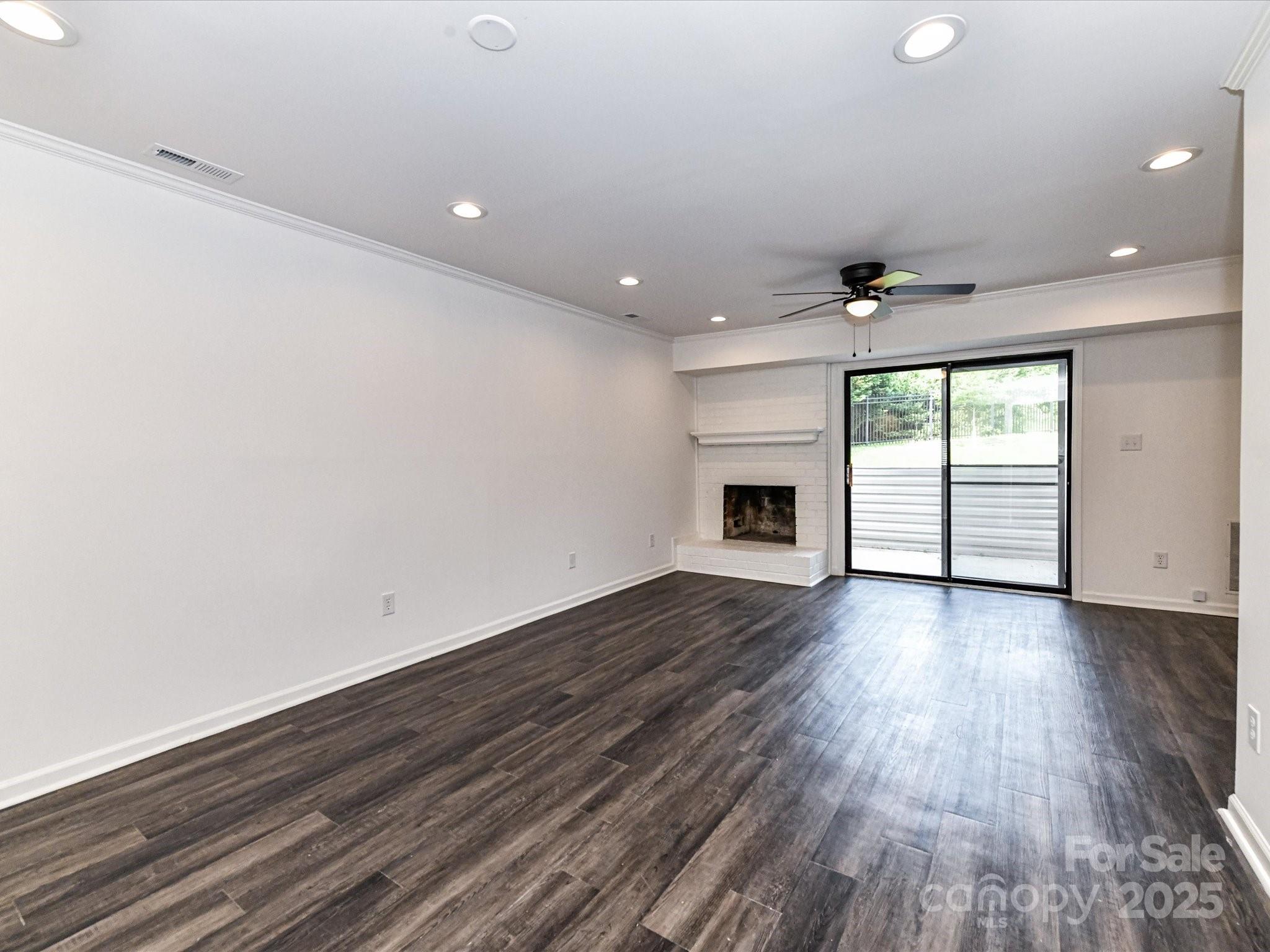 11020 Carmel Crossing Road Charlotte, NC 28226 - Photo 15 of 30 an empty room with wooden floor and a window