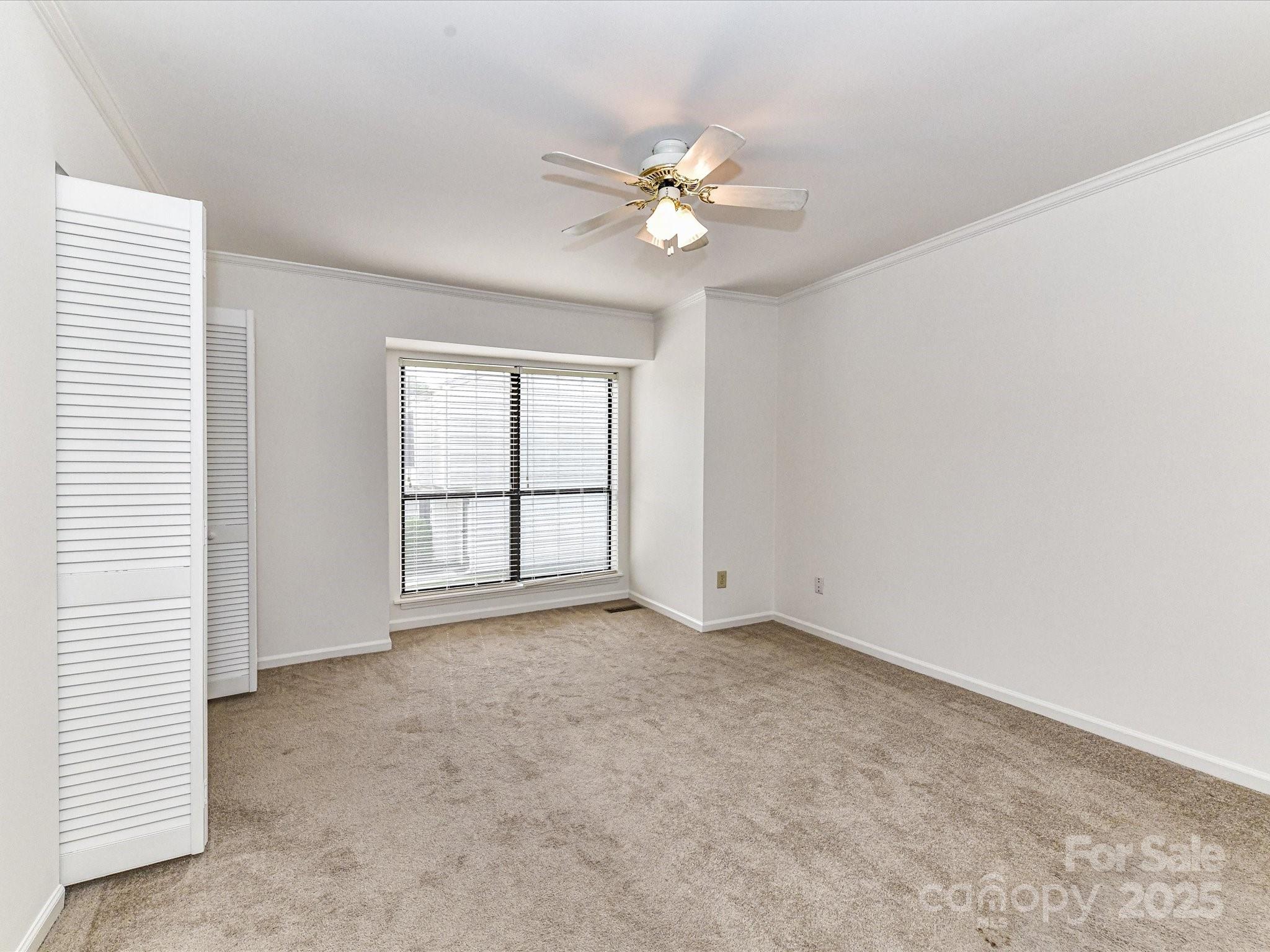 11020 Carmel Crossing Road Charlotte, NC 28226 - Photo 20 of 30 an empty room with windows and fan