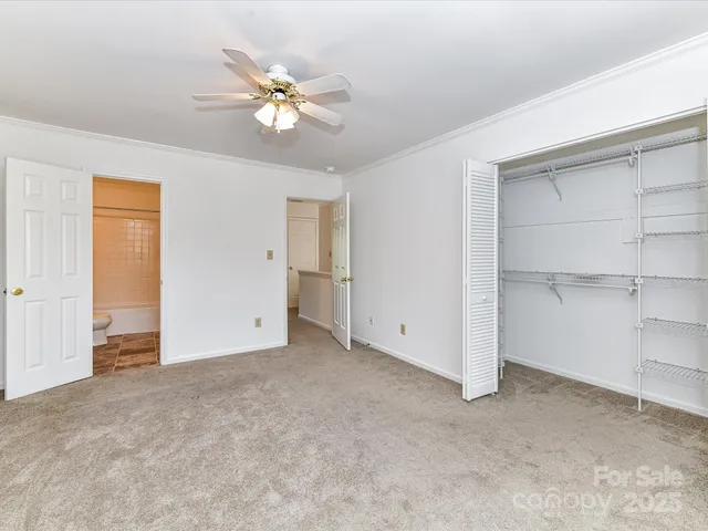 a view of an empty room with a ceiling fan
