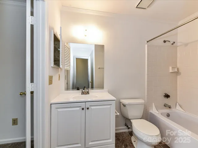a bathroom with a sink toilet vanity and shower