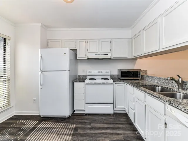 a kitchen with a white cabinets and white appliances