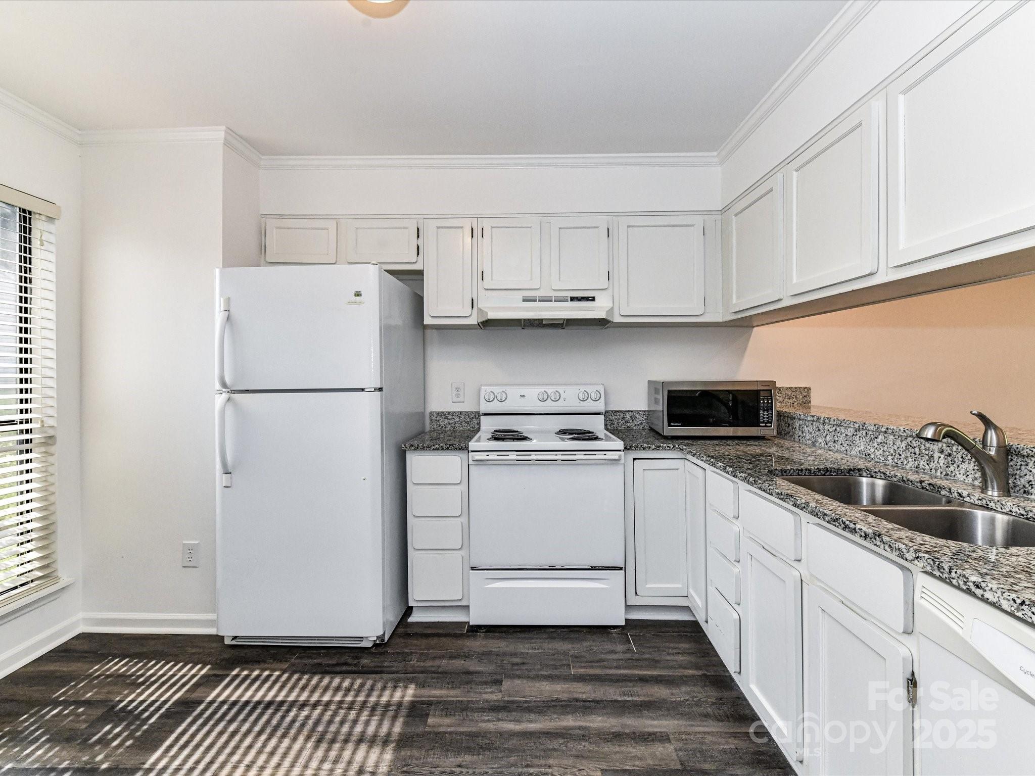 11020 Carmel Crossing Road Charlotte, NC 28226 - Photo 8 of 30 a kitchen with a white cabinets and white appliances