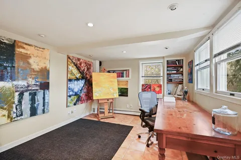 an aerial view of residential houses with outdoor space and parking