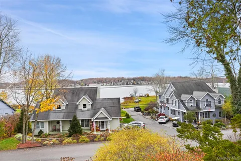 a view of a roof deck with table and chairs wooden floor and fence
