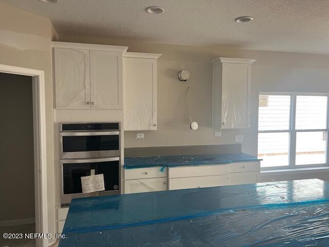 233 Bermudez Way St. Augustine, FL 32095 - Photo 3 of 12 a view of kitchen and empty room with wooden floor