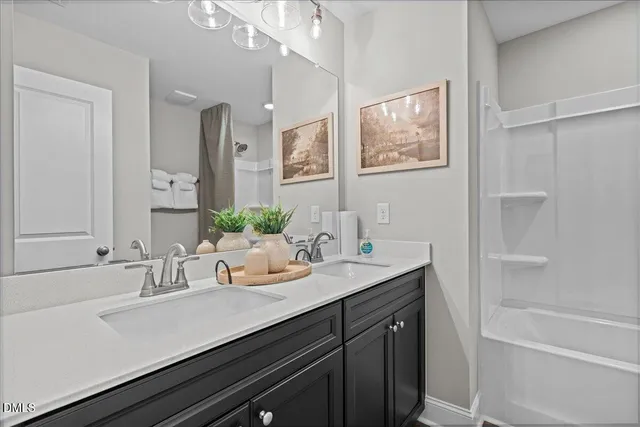 a bathroom with a sink double vanity and a bathtub