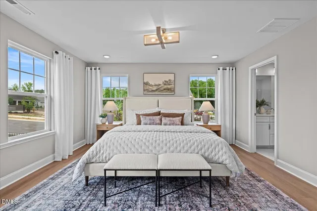 a bedroom with a bed rug and wooden floor
