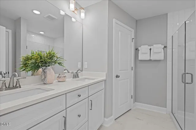 a bathroom with a double vanity sink and mirror