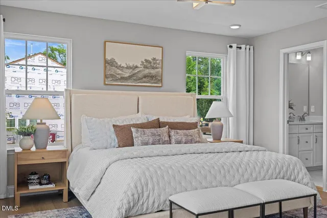 a bedroom with a bed and a painting on the wall