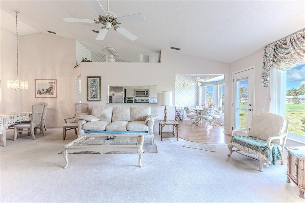 2420 Rolling View Drive Spring Hill, FL 34606 - Photo 15 of 62 a living room with furniture and a chandelier