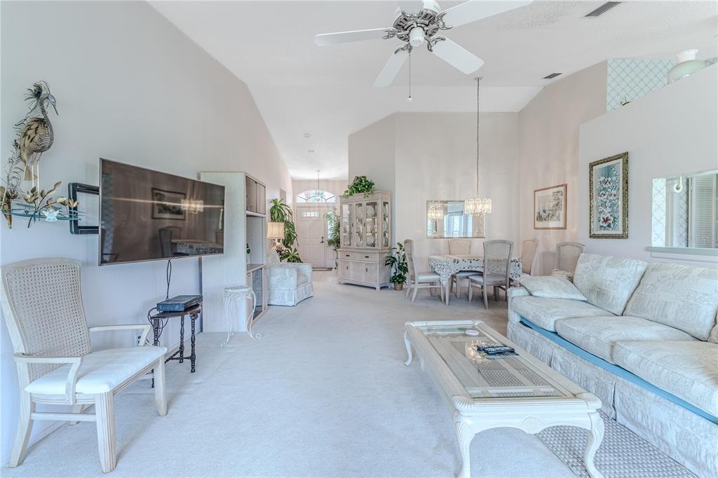 2420 Rolling View Drive Spring Hill, FL 34606 - Photo 16 of 62 a living room with furniture and a flat screen tv