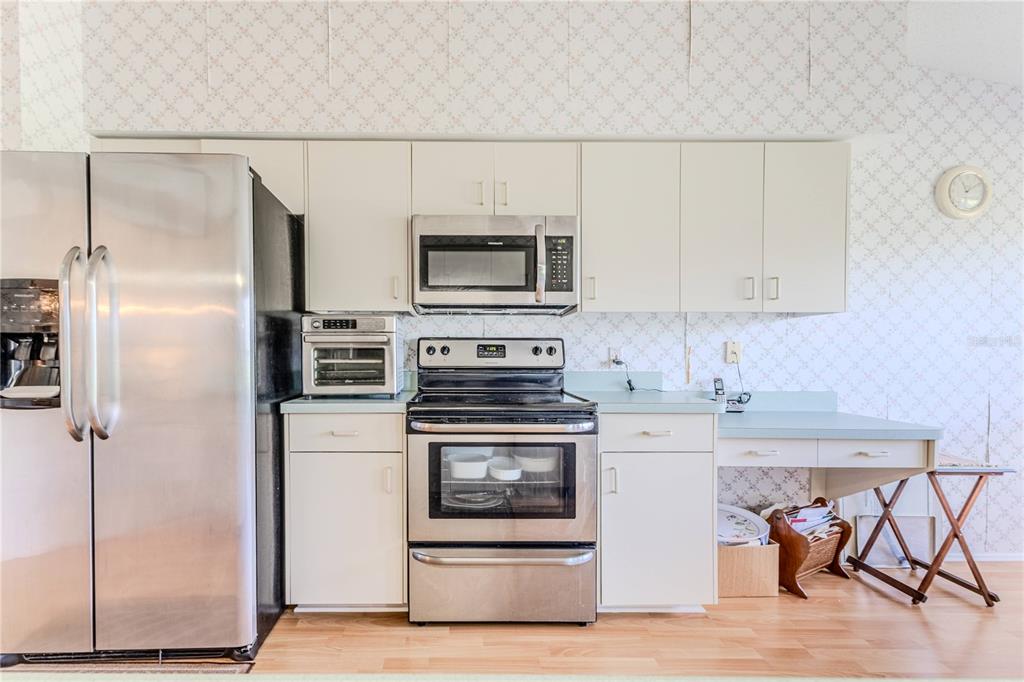 2420 Rolling View Drive Spring Hill, FL 34606 - Photo 19 of 62 a kitchen with a stove a refrigerator and a microwave