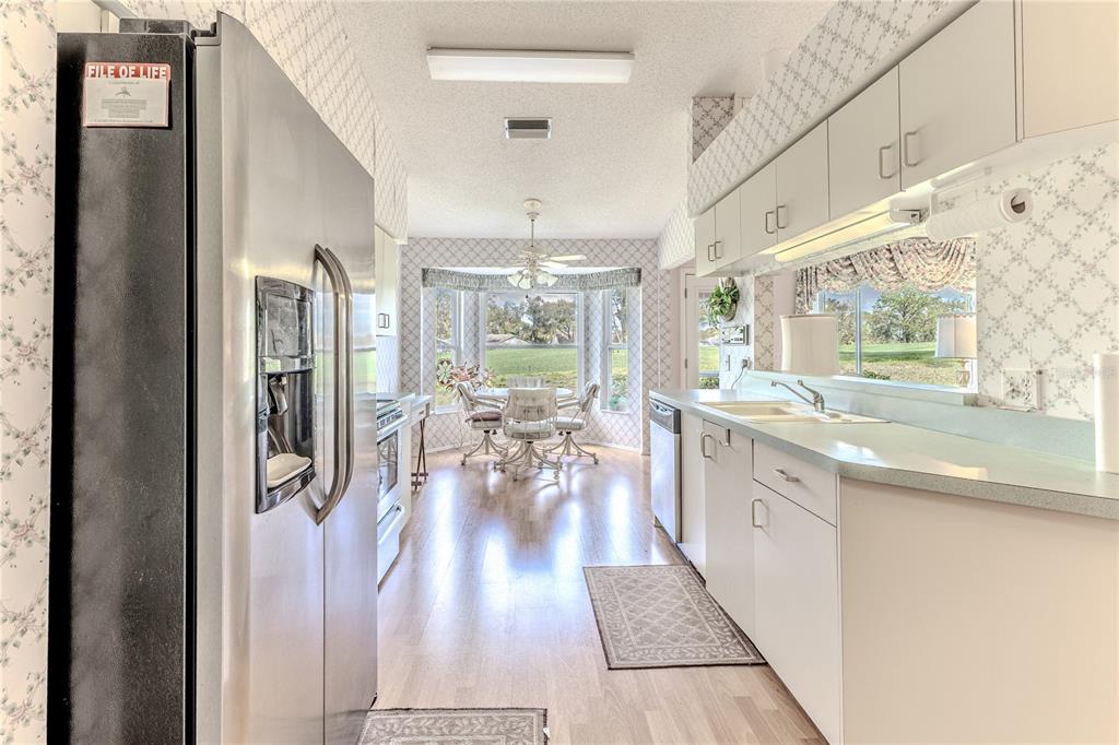2420 Rolling View Drive Spring Hill, FL 34606 - Photo 21 of 62 a kitchen with stainless steel appliances lots of counter top space and wooden floor