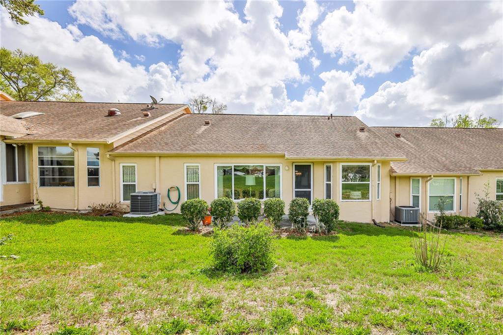 2420 Rolling View Drive Spring Hill, FL 34606 - Photo 32 of 62 a view of a house with a big yard and plants