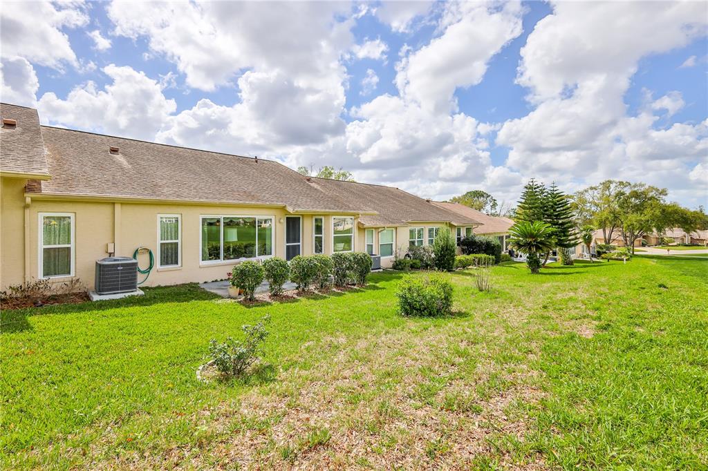 2420 Rolling View Drive Spring Hill, FL 34606 - Photo 33 of 62 a view of a house with backyard sitting area and garden