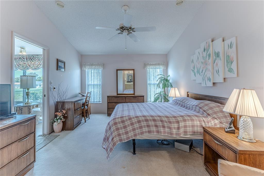2420 Rolling View Drive Spring Hill, FL 34606 - Photo 37 of 62 a bedroom with a bed and a chandelier