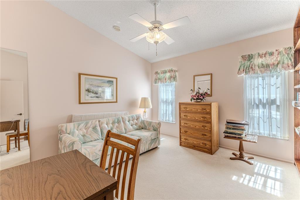 2420 Rolling View Drive Spring Hill, FL 34606 - Photo 6 of 62 a bedroom with furniture and a chandelier