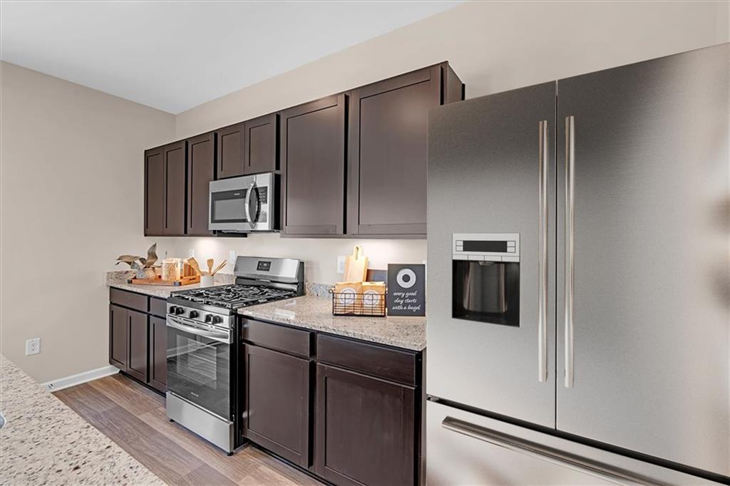 117 Lavender Circle Calhoun, GA 30701 - Photo 11 of 29 a kitchen with stainless steel appliances granite countertop a refrigerator stove a sink and dishwasher