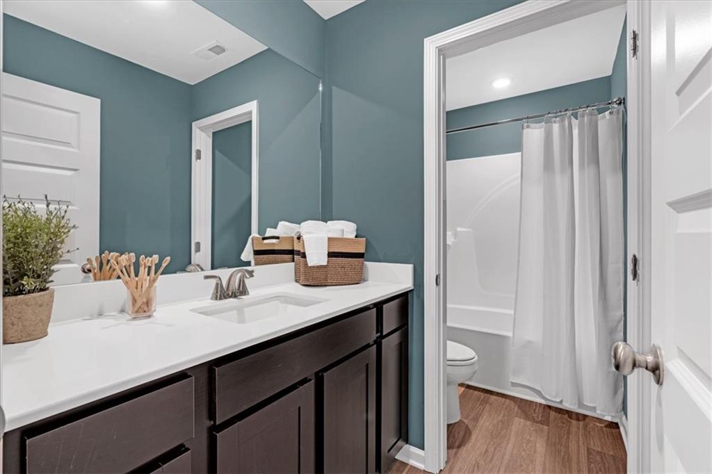 117 Lavender Circle Calhoun, GA 30701 - Photo 23 of 29 a bathroom with a sink a mirror and a shower