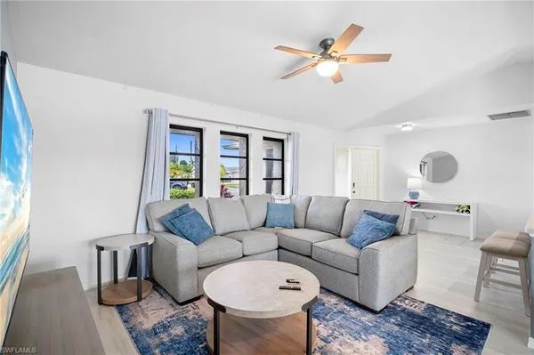 a living room with furniture and a large window