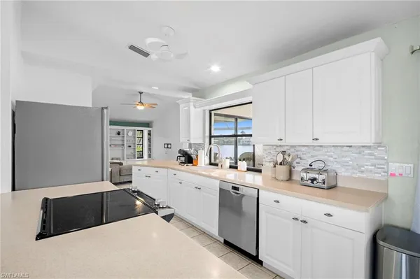 a kitchen with a sink cabinets and window
