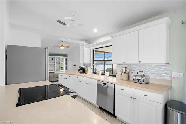 a kitchen with a sink cabinets and window