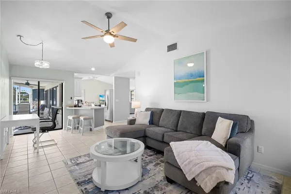 a living room with furniture and white walls