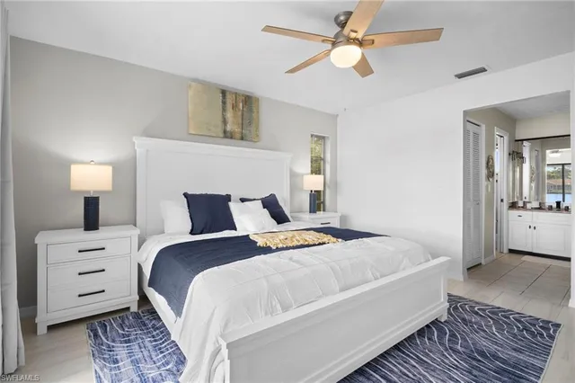 a bedroom with a bed and a lamp