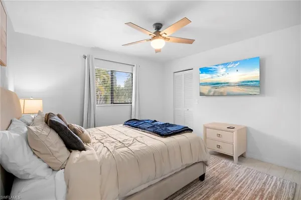a bedroom with a large bed and a window