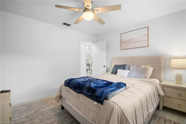 a bedroom with a bed and a ceiling fan