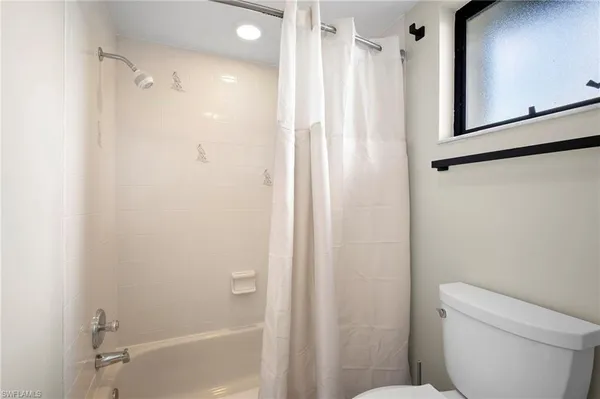a bathroom with a shower and a toilet