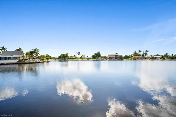 a view of a lake with houses in the background