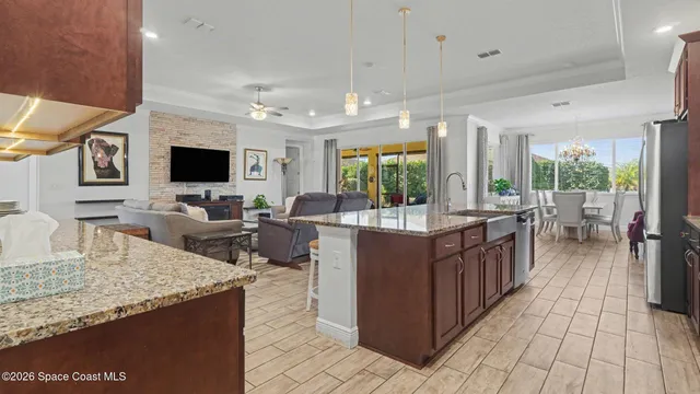 a kitchen with counter top space and living room view
