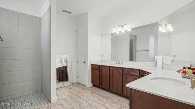 a bathroom with a tub sink and mirror