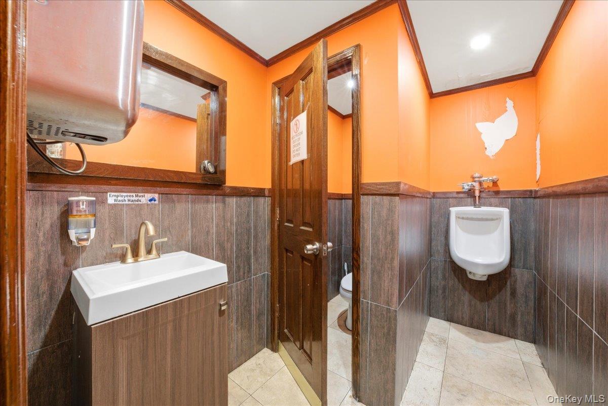 1435 2nd Avenue Manhattan, NY 10021 - Photo 12 of 33 a bathroom with a sink a toilet and a mirror