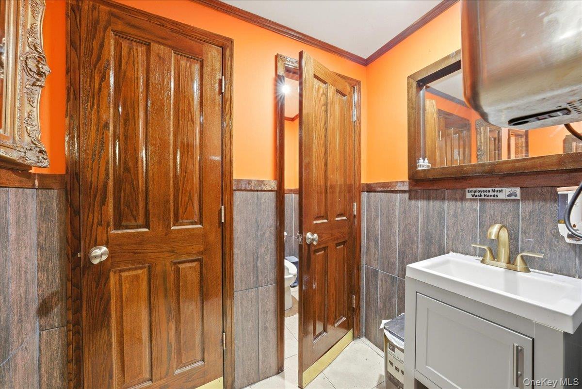1435 2nd Avenue Manhattan, NY 10021 - Photo 13 of 33 a bathroom with a sink a mirror and a shower
