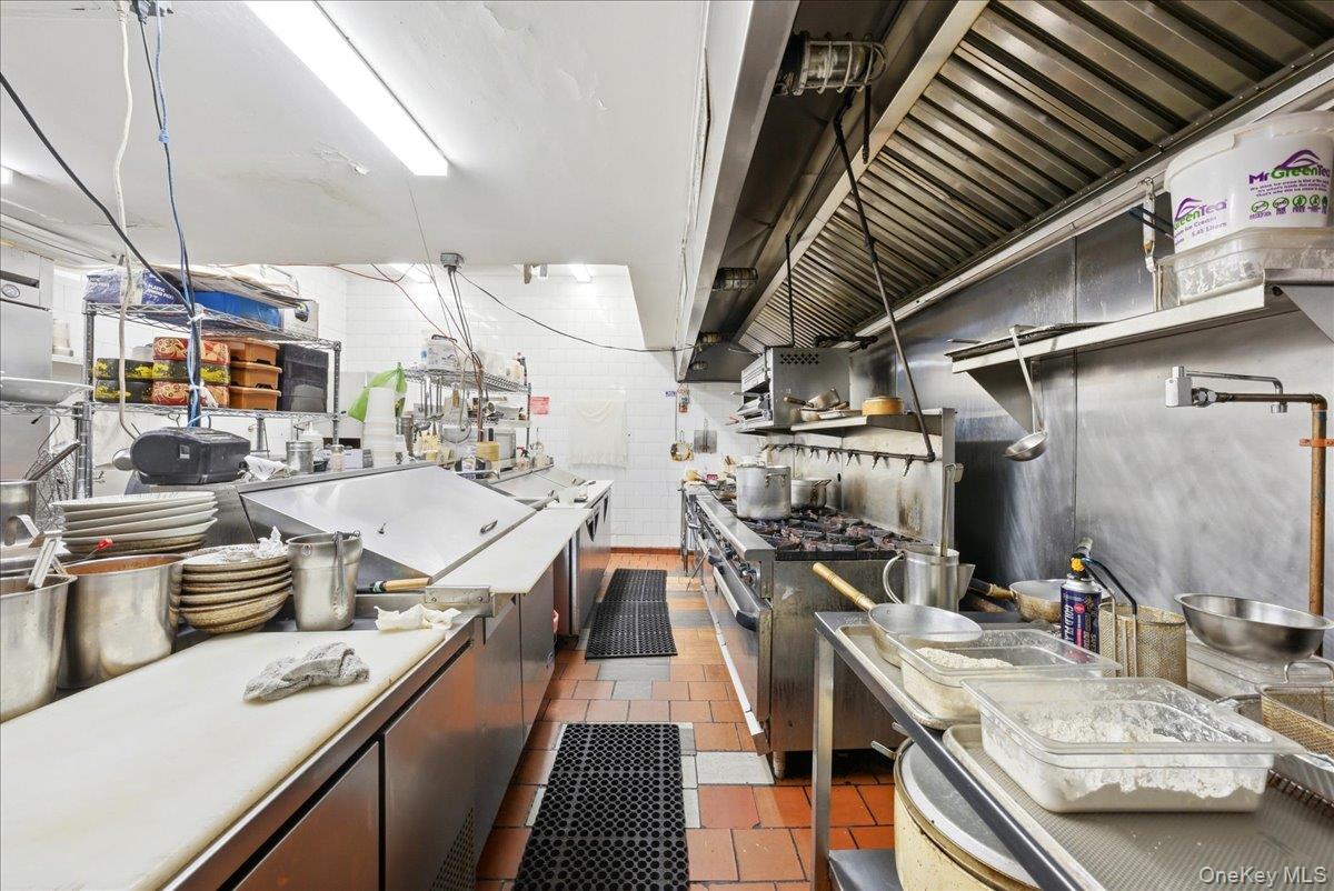 1435 2nd Avenue Manhattan, NY 10021 - Photo 16 of 33 a kitchen with stainless steel appliances granite countertop a sink and stove