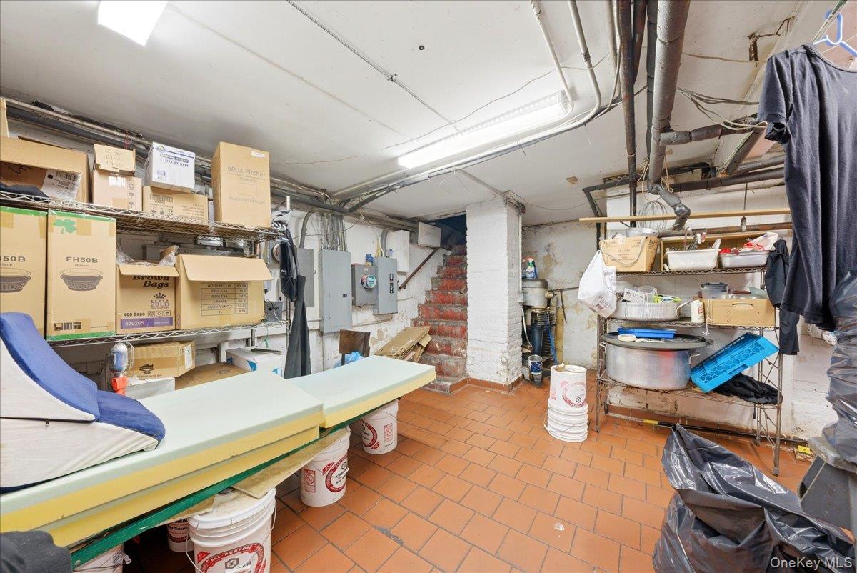 1435 2nd Avenue Manhattan, NY 10021 - Photo 20 of 33 a room with lots of wooden furniture and a chandelier