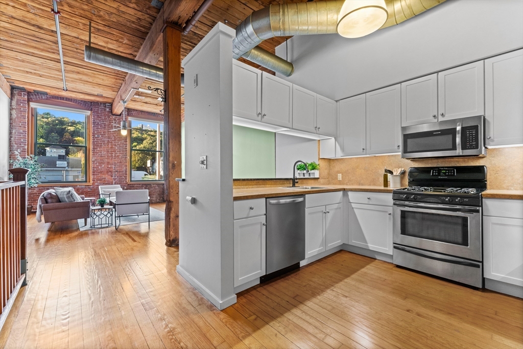 1 Envelope Terrace, Unit 110 Worcester, MA 01604 - Photo 3 of 15 a kitchen with stainless steel appliances a stove a sink and a refrigerator