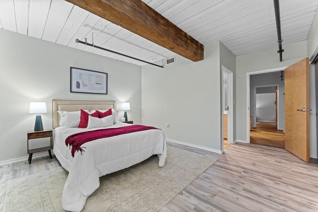 1 Envelope Terrace, Unit 110 Worcester, MA 01604 - Photo 6 of 15 a bed room with a bed and a night stand