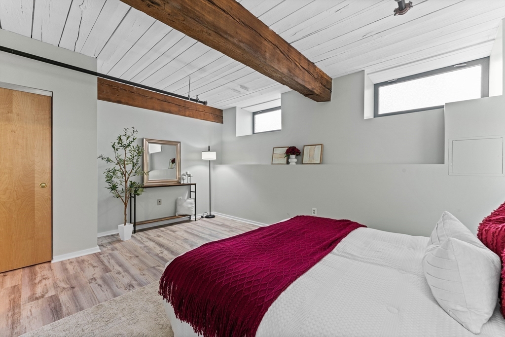 1 Envelope Terrace, Unit 110 Worcester, MA 01604 - Photo 7 of 15 a bedroom with a bed and a table