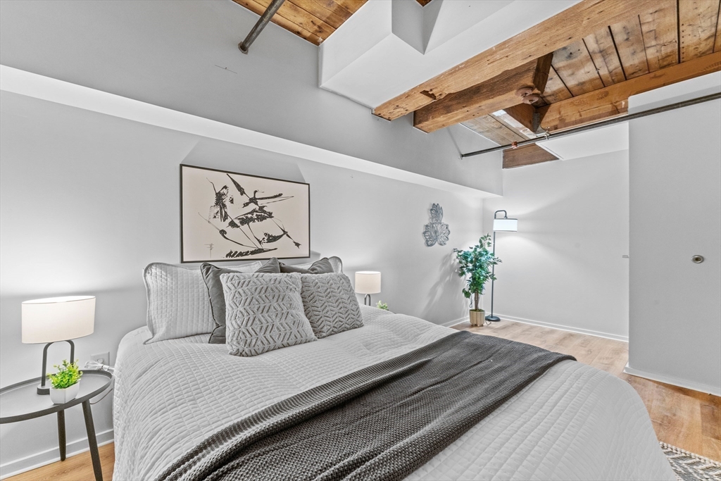 1 Envelope Terrace, Unit 110 Worcester, MA 01604 - Photo 9 of 15 a bedroom with bed and wooden floor