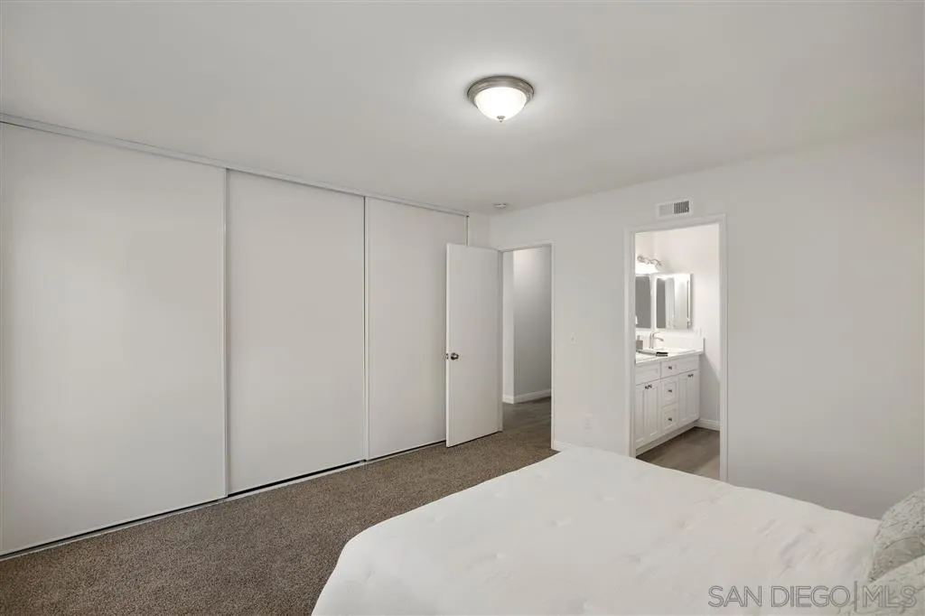 439 Mainsail Road Oceanside, CA 92054 - Photo 18 of 25 a bedroom with a bed and hallway