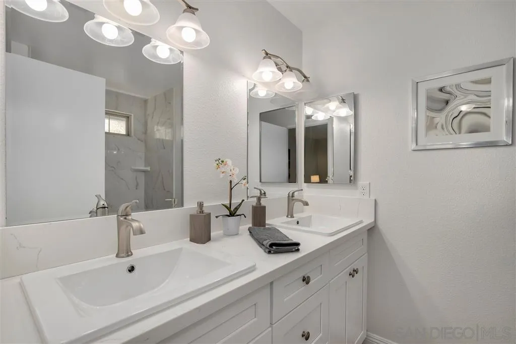439 Mainsail Road Oceanside, CA 92054 - Photo 21 of 25 a bathroom with a double vanity sink and a mirror