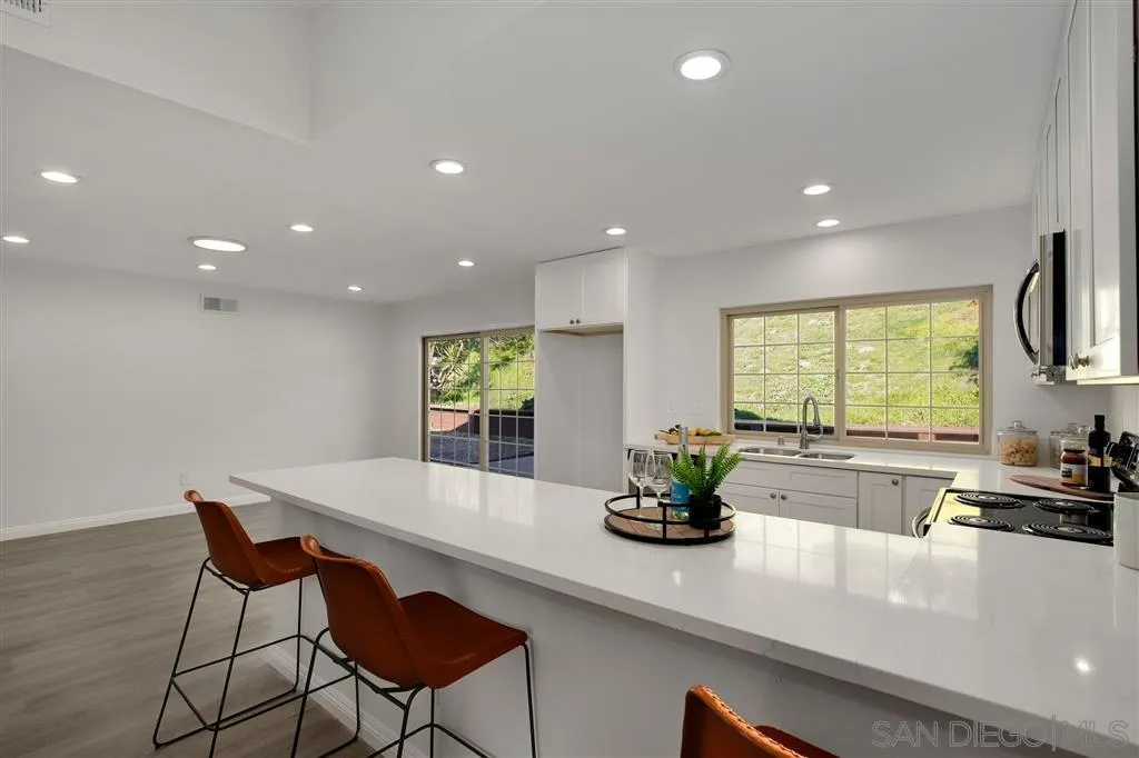 439 Mainsail Road Oceanside, CA 92054 - Photo 10 of 25 a kitchen with a dining table and chairs